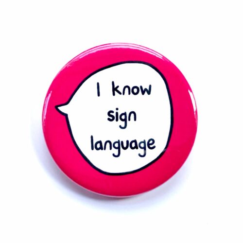 'I know sign language' pin badge with pink background