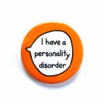 'I have a personality disorder' pin badge with orange background