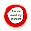 'Ask me about my pronouns' pin badge with red background